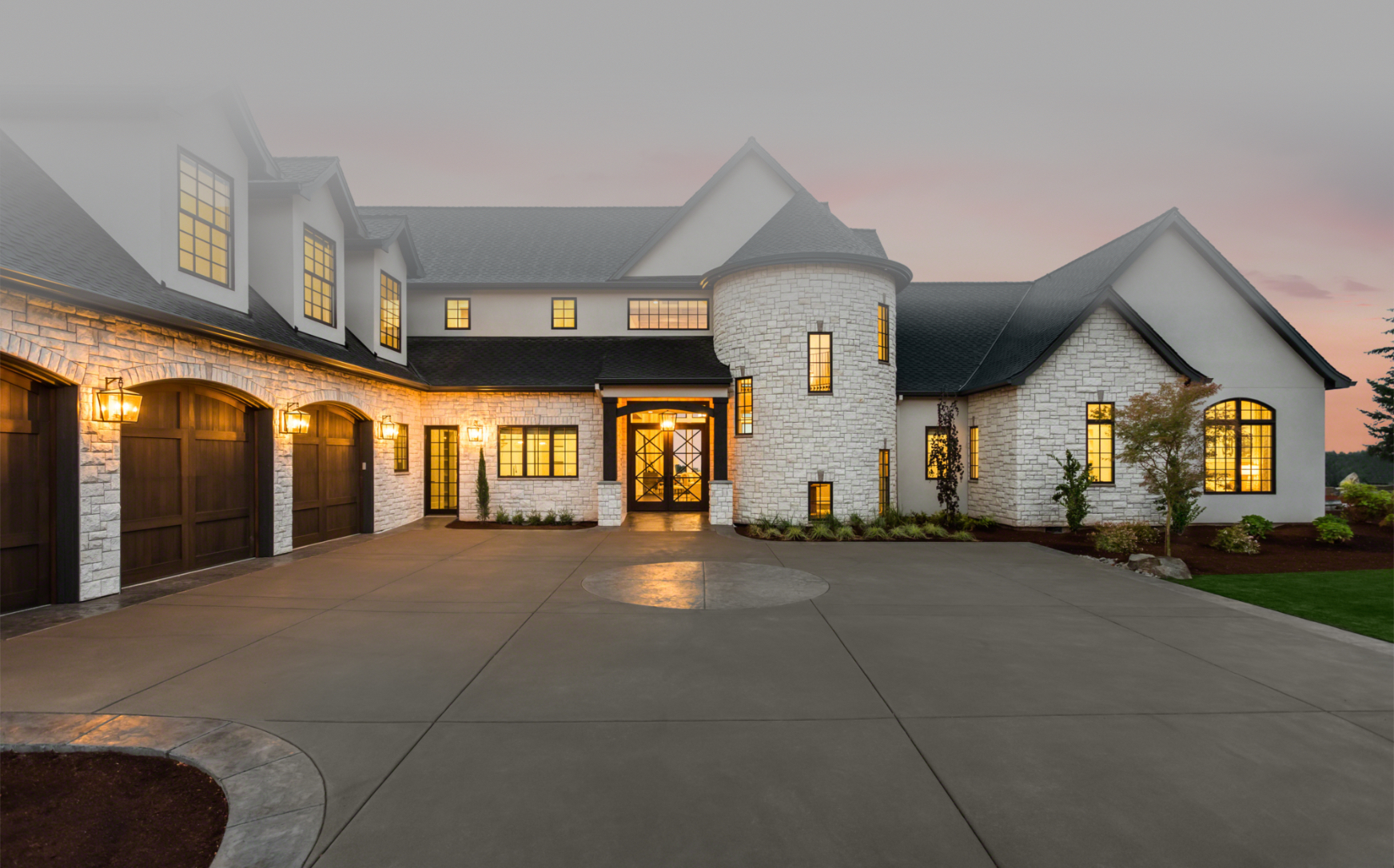 Large luxury home exterior at dusk